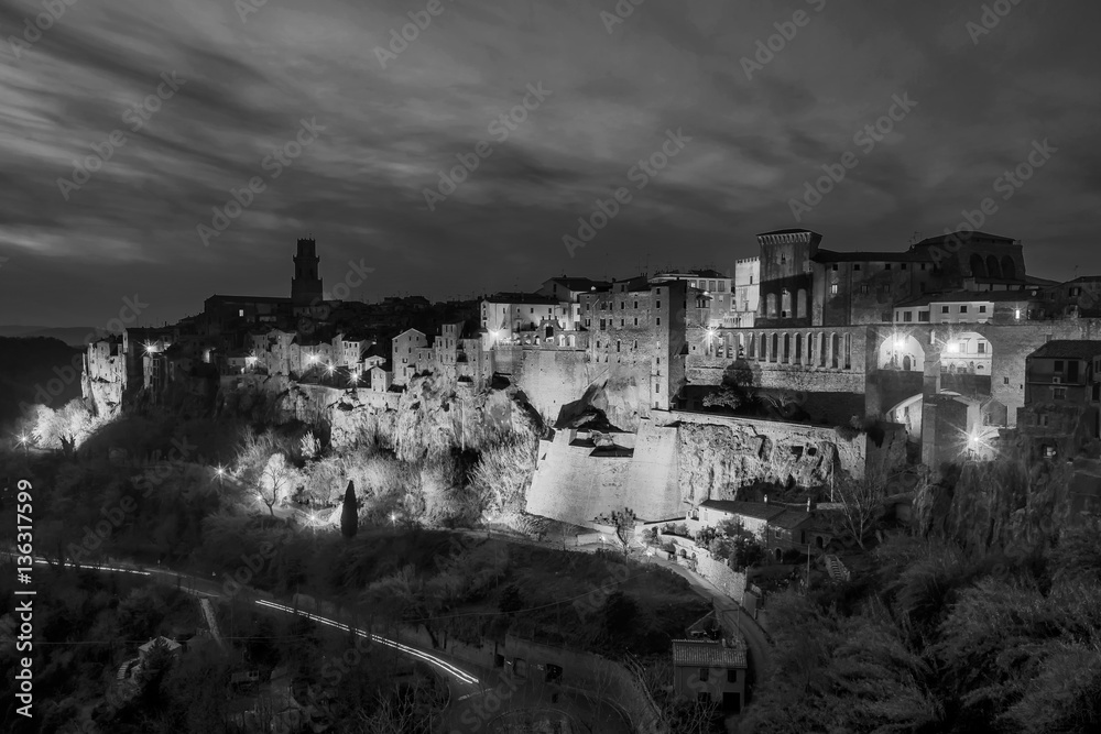 Superb black and white view of Pitigliano, a village famous for being built on the tuff, Grosseto, Tuscany, Italy, in the evening light Superb black and white view of Pitigliano, a village famous for being built on the tuff, Grosseto, Tuscany, Italy, in the evening light