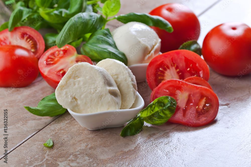 mozzarella with tomato and basil in small white dish mozzarella with tomato and basil in small white dish