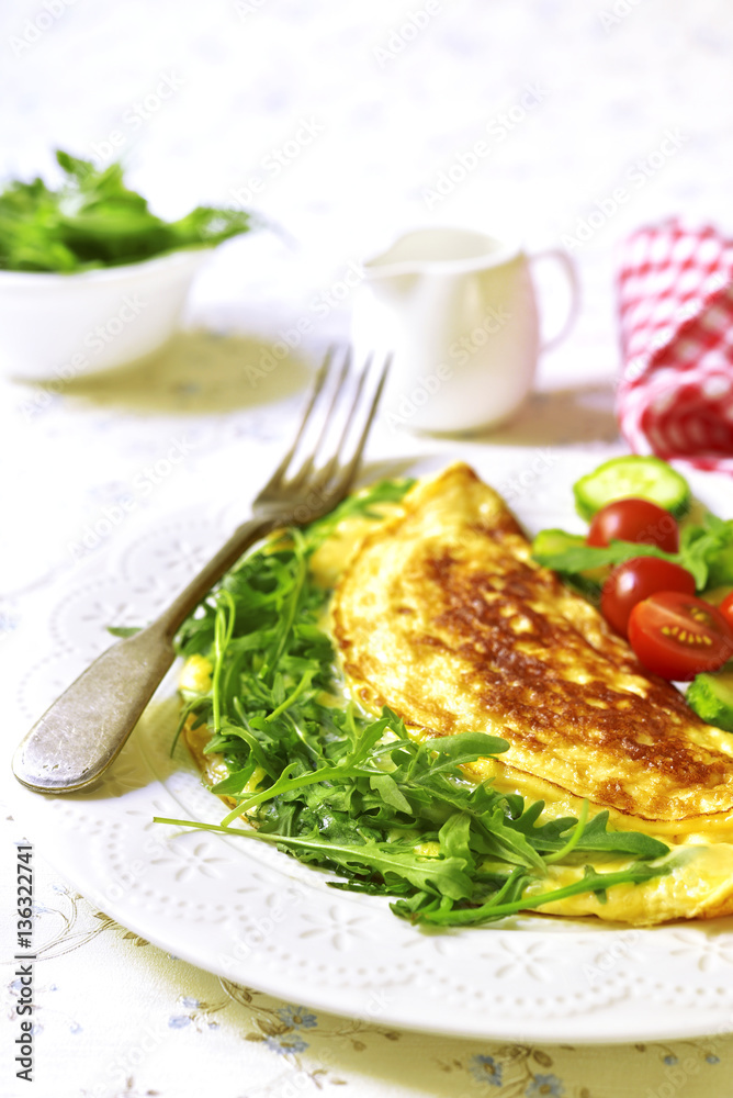 Omelet with cheese and arugula - healthy diet breakfast on white Omelet with cheese and arugula - healthy diet breakfast on white