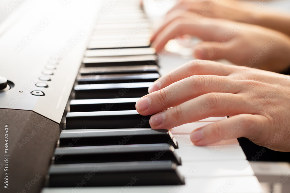 Fototapeta premium Closeup of hands playing piano. Music and hobby concept