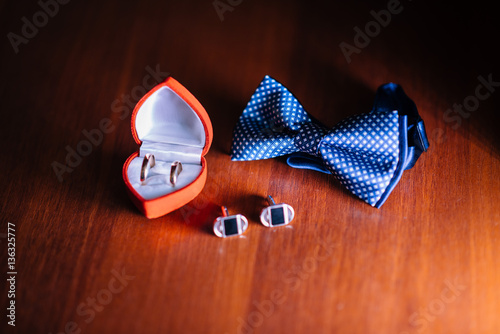 Groom accessories. Shoes, rings, belt, and bowtie photo