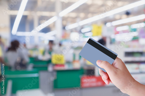paying using credit card at supermarket checkout cashier