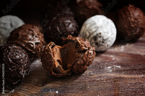 Chocolate, truffle pralines with nougat cream on dark rustic wood photo