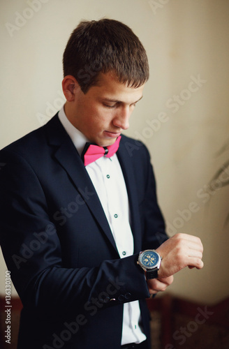 stylish groom wears laxury watches