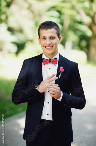 groom smiling  with blue eyes blue suit