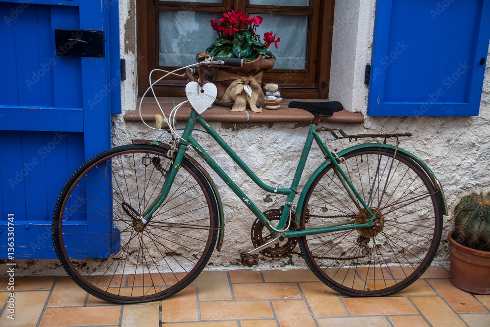 Vintage old bicycle in front of cute flowered house in Spain