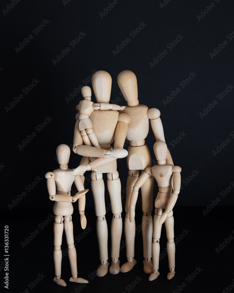 Photos wooden dolls, happy family with children on black background Photos wooden dolls, happy family with children on black background