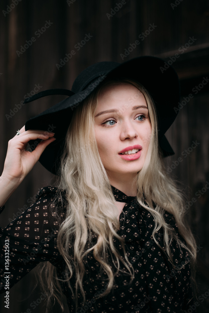 Beautiful attractive and stylish girl wearing black hat standing posing in city. Nude makeup, best daily hairstyle and great fashion glamour country style. Beautiful attractive and stylish girl wearing black hat standing posing in city. Nude makeup, best daily hairstyle and great fashion glamour country style.