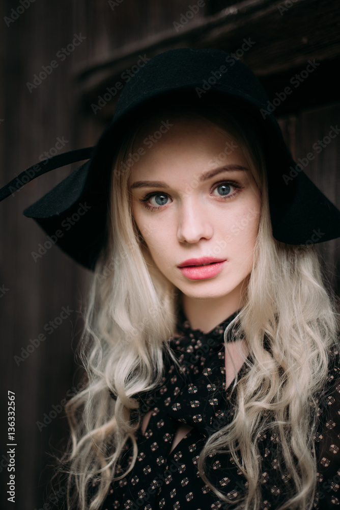 Beautiful attractive and stylish girl wearing black hat standing posing in city. Nude makeup, best daily hairstyle and great fashion glamour country style. Beautiful attractive and stylish girl wearing black hat standing posing in city. Nude makeup, best daily hairstyle and great fashion glamour country style.