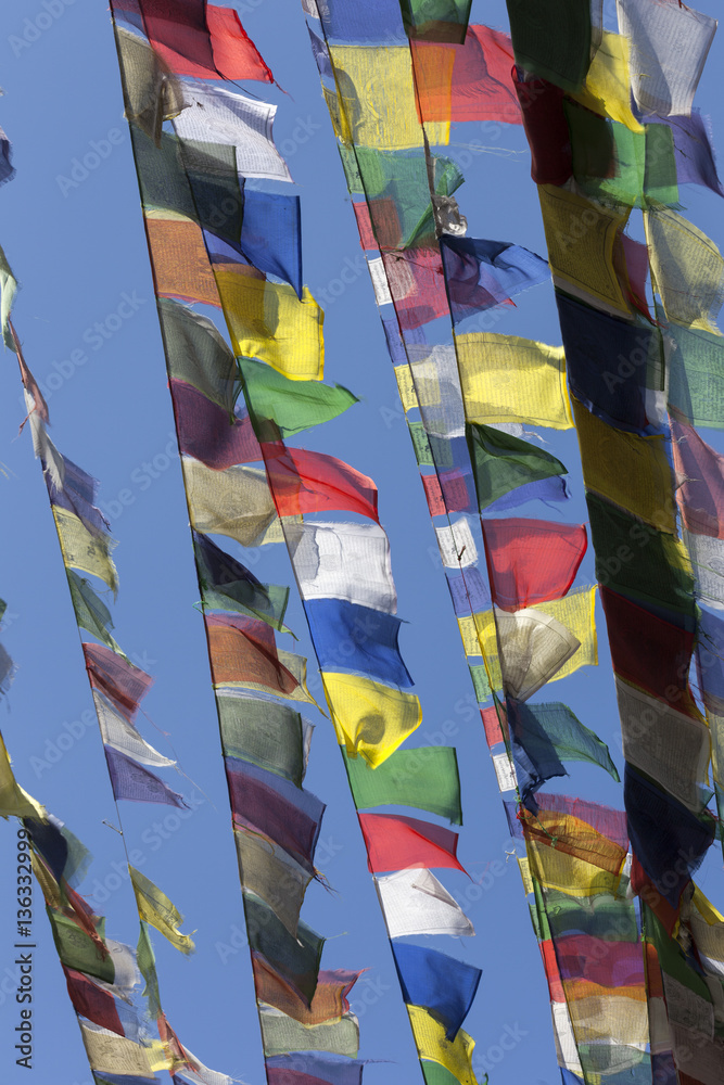 coloured prayer flags against a blue sky