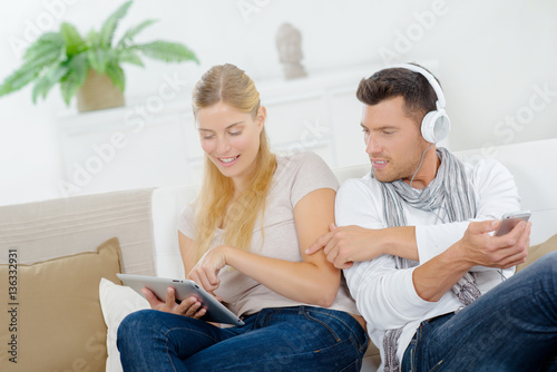 man and woman with gadgets