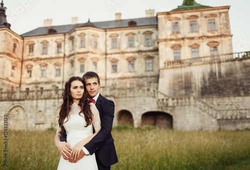 embracing couple looking to the side