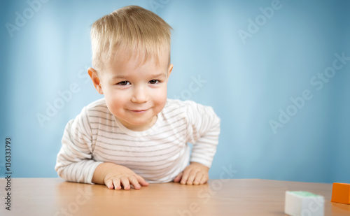 Portrait of a two years old child sitting at the table