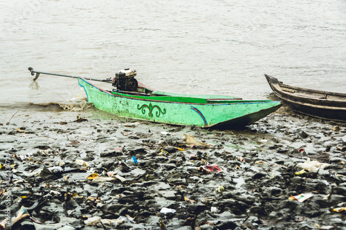 Burmese homemade motor boat resting on riverbank, Irrawaddy delta, Myanmar - 1 photo