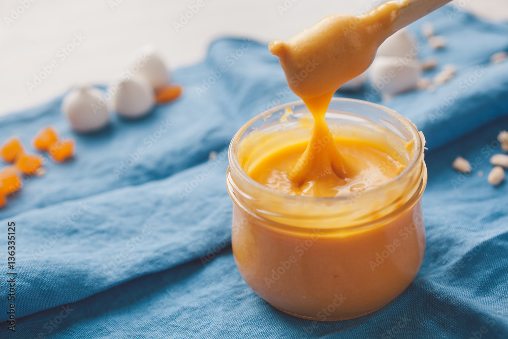 Honey dipper with orange zest honey on blue napkin background. Honey dipper with orange zest honey on blue napkin background.