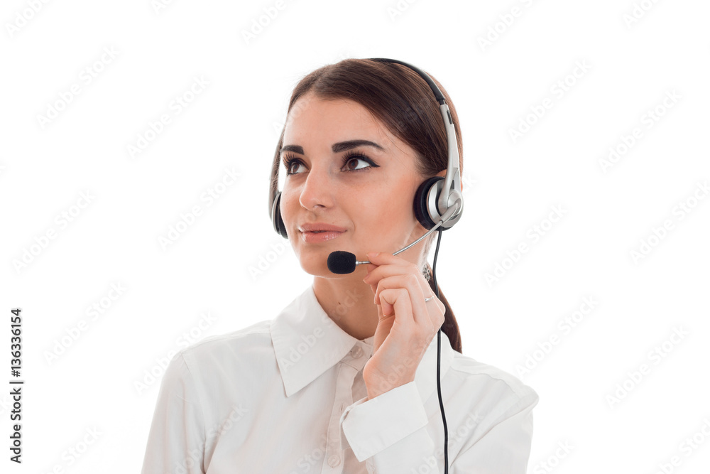 portrait of young beautiful call center worker girl with headphones and microphone posing isolated on white background portrait of young beautiful call center worker girl with headphones and microphone posing isolated on white background