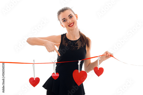 Happy young brunette woman with red heart in hands posing isolated on white background. Saint Valentine's day concept. Love concept.