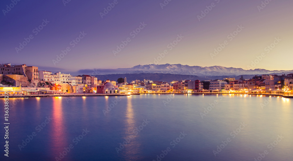 Panorama of the beautiful old harbor of Chania with the amazing lighthouse, at sunset, Crete, Greece.