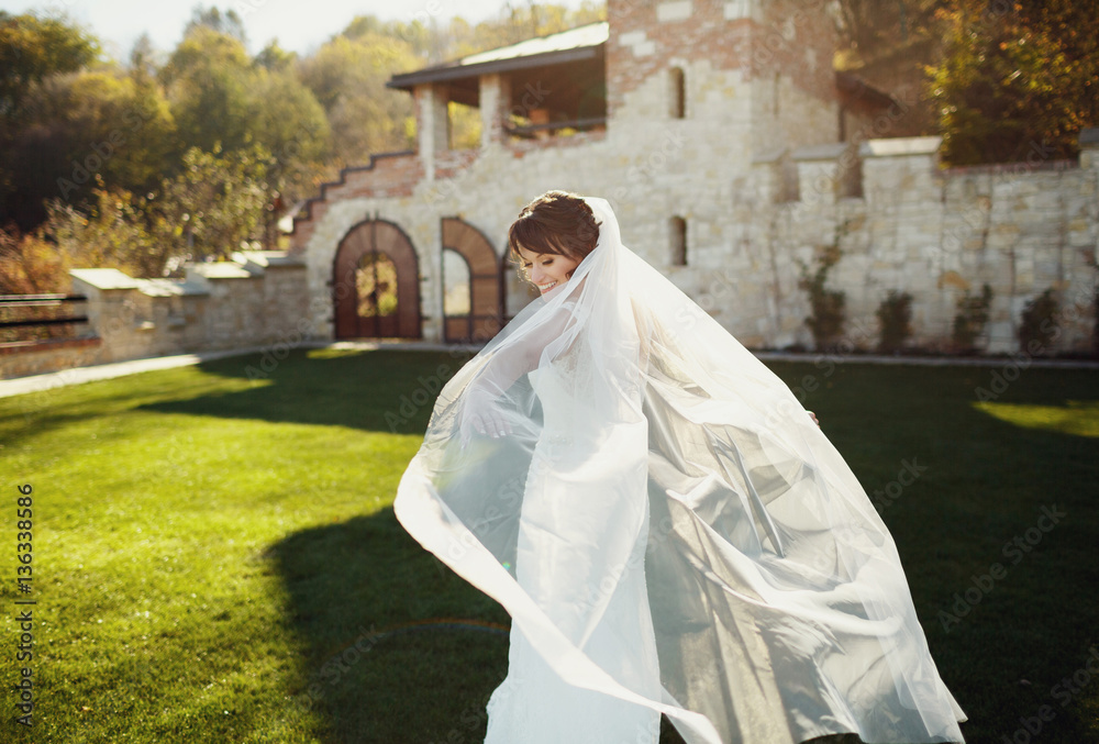 Wedding rejoicing with white veil outside