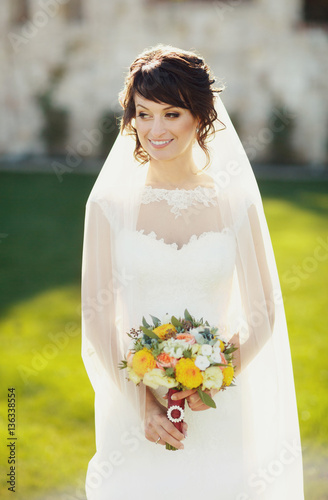 Happy bride hold the wedding bouquet