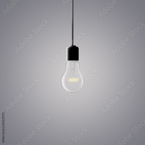 glowing light bulb on a dark gray background