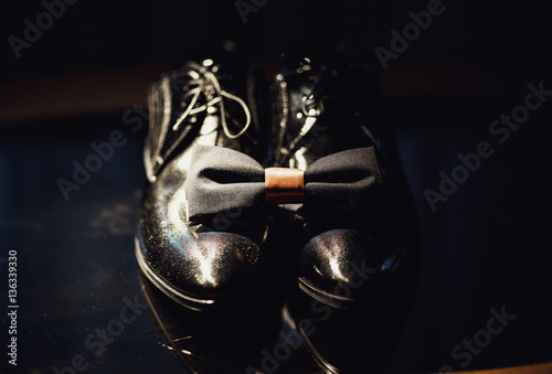 Groom's tie and shoes on the table
