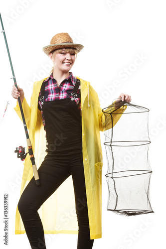 Happy woman holding fishing rod and keepnet photo