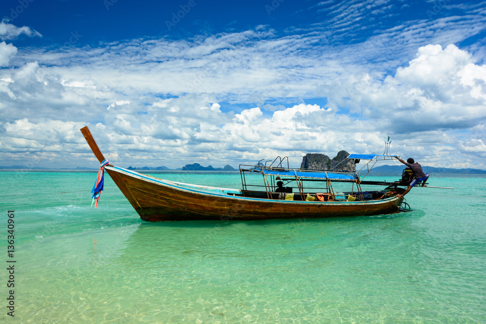 Traditional travel boat in sea with green water