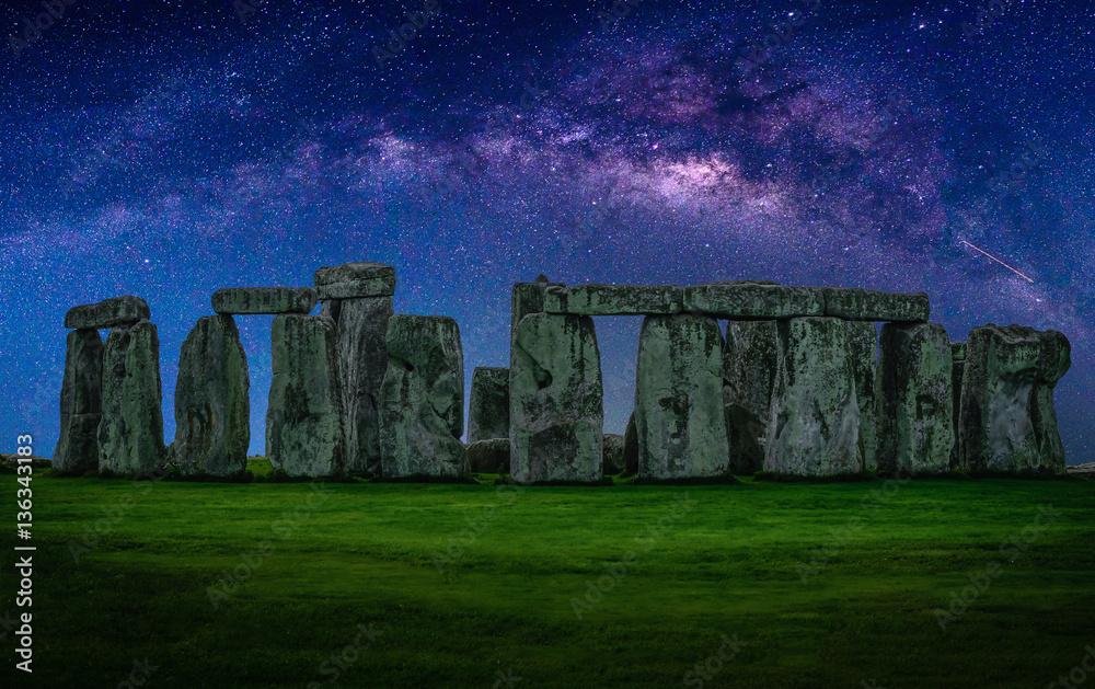 Fototapeta premium Landscape image of Milky way galaxy at night sky with stars over Stonehenge an ancient prehistoric stone monument, Wiltshire, UK.
