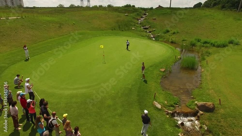 Aerial video footage of golfer on a golf course make his putt