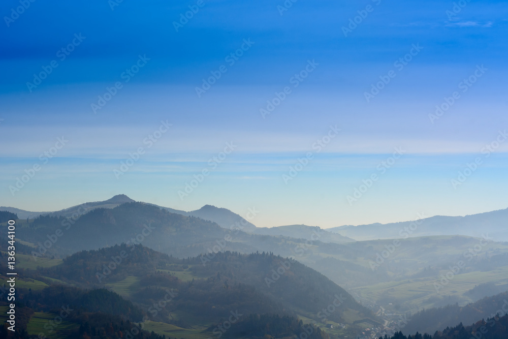 Blue sky and misty mountains
