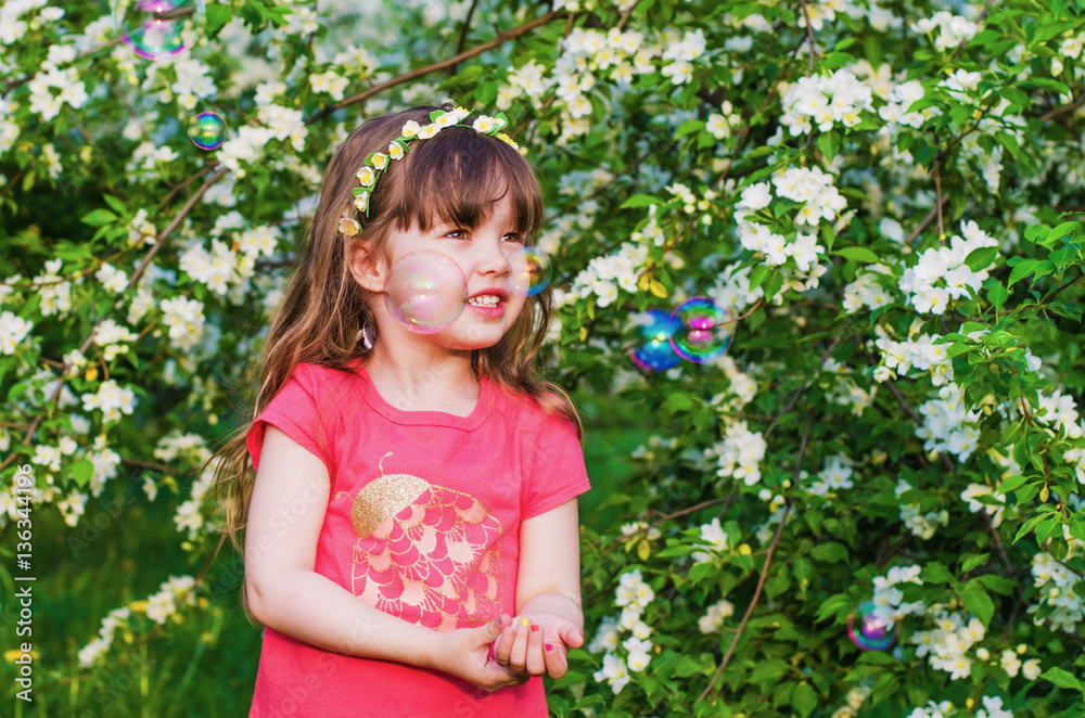 little girl in blossoming Apple orchard