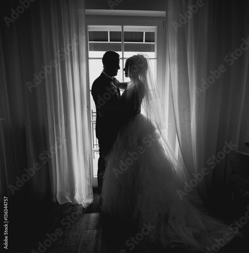 Beautiful romantic newlyweds in the room b&w