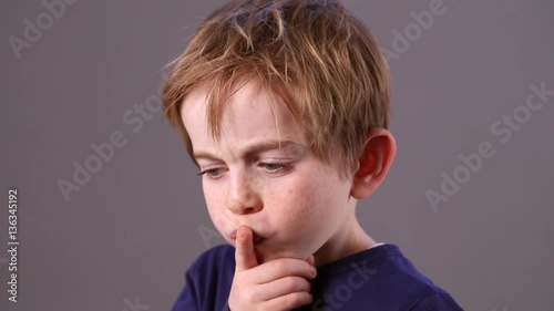 thoughtful young kid looking away to imagine, think and concentrate