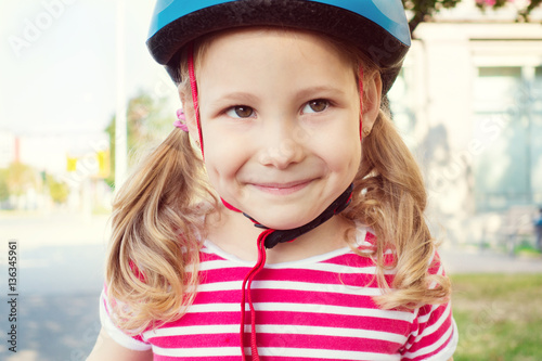 Pretty little child girl ride and having fun with bicycle in par