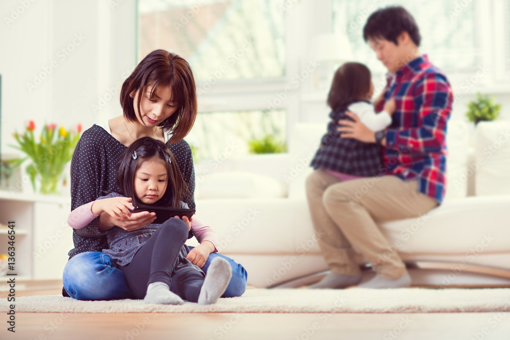 Young happy family with pretty daughters playing and having fun Young happy family with pretty daughters playing and having fun