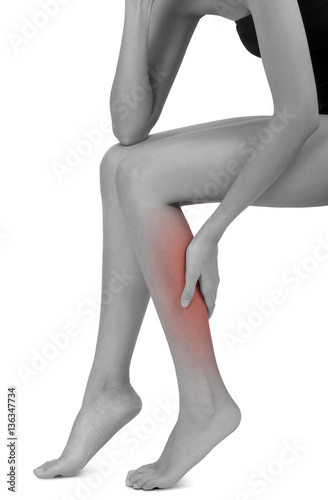 woman sitting and holding  with massaging her calf  in pain area black and white color with red highlighted, Isolated on white background.