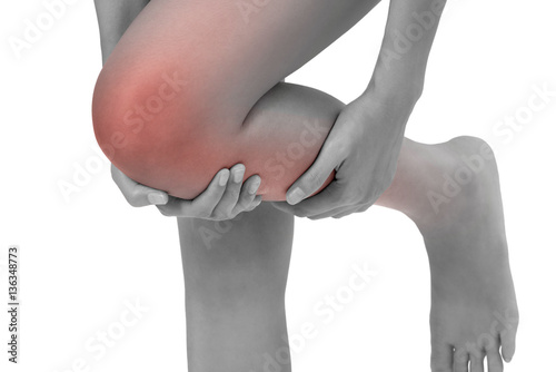 woman holding her leg with massaging knee and calf in pain area black and white color with red highlighted isolated on white background