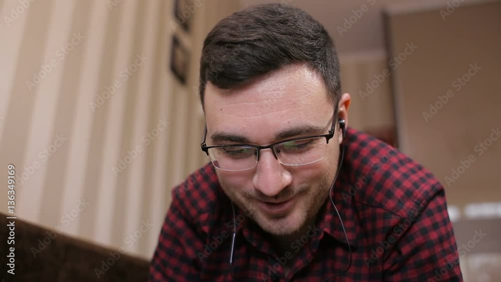 Young man having a telephone conversation with earphones Young man having a telephone conversation with earphones