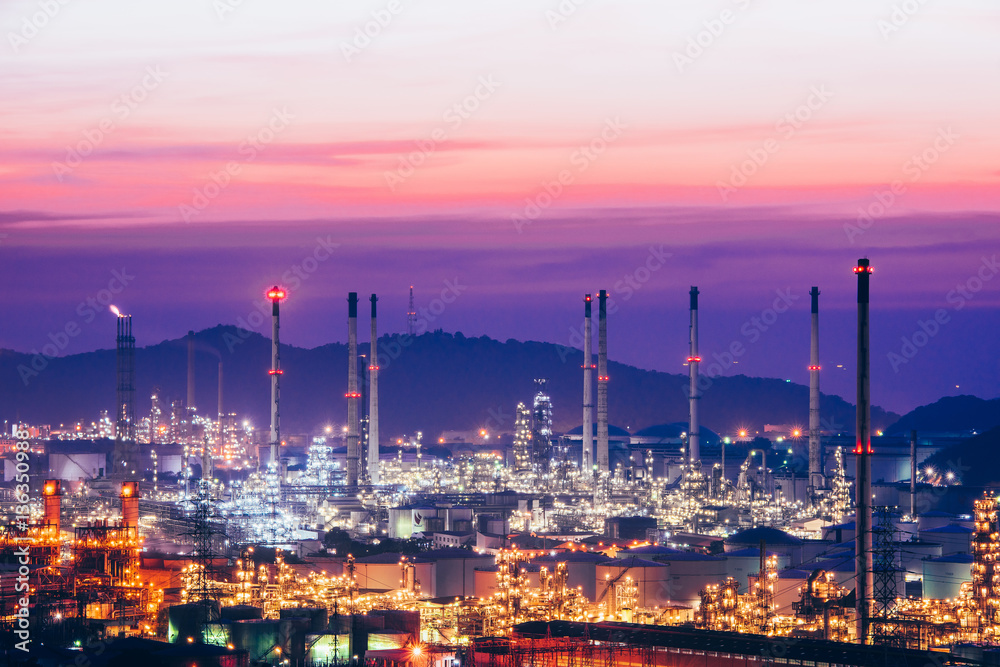 Aerial view oil refinery night with mountain background during twilight,Industrial zone,Energy power station.