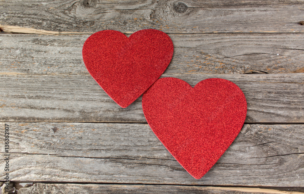 2 red hearts on a rustic wood background 2 red hearts on a rustic wood background