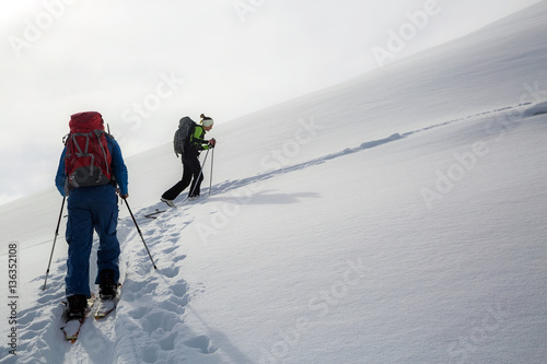 Man standing at top of ridge. Ski touring in mountains. Adventure winter extreme sport. kyrgyzstan. Tian-Shan photo