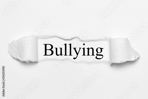 Bullying on white torn paper photo