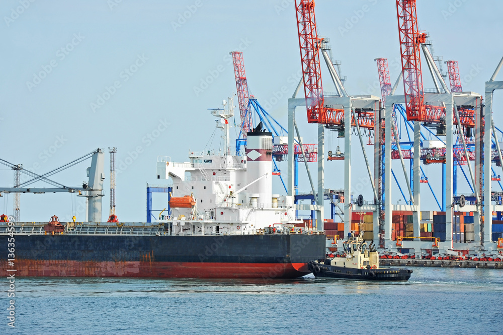 Tugboat assisting bulk cargo ship Tugboat assisting bulk cargo ship