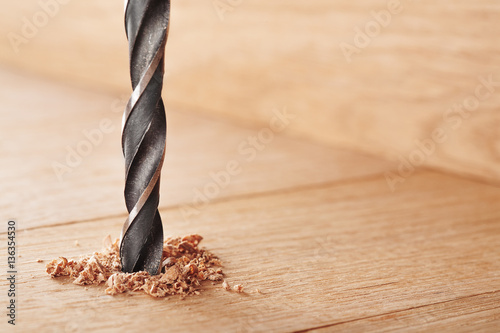 metal drill bit make holes in wooden oaks plank photo