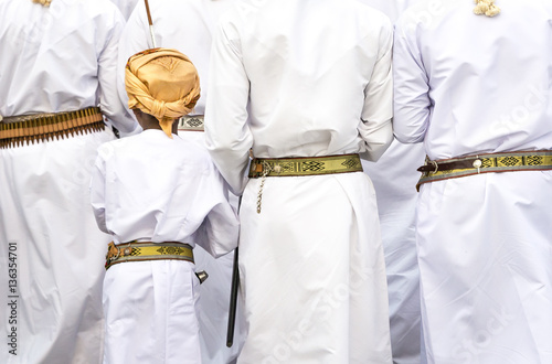 omani men in traditional clothing singing