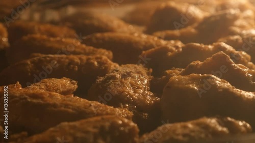 Chicken meat baking in tray close-up 4K 2160p 30fps UltraHD panning footage - Cooking of buffalo wings in electric oven after cooking slow pan 3840X2160 UHD video