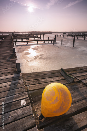 Eis auf dem Neusiedlersee mit gelber Boje im Vordergrund photo
