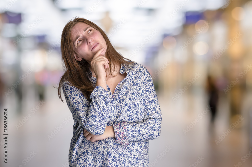 Thoughtful young hipster woman over blur background Thoughtful young hipster woman over blur background