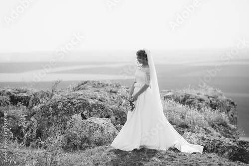 Photos Young bride walking in park.